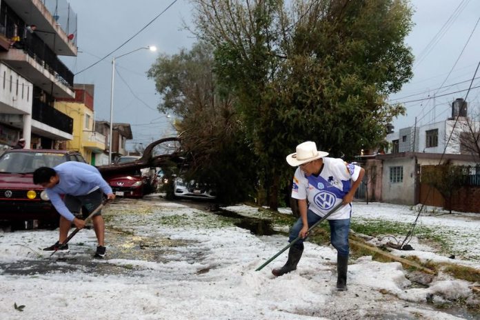 Puebla residents shovel hail that seemingly struck out of nowhere on Saturday.