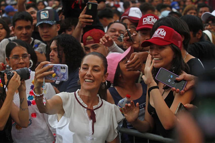 Mexico presidential candidate Claudia Sheinbaum taking a selfie with supporters at a rally