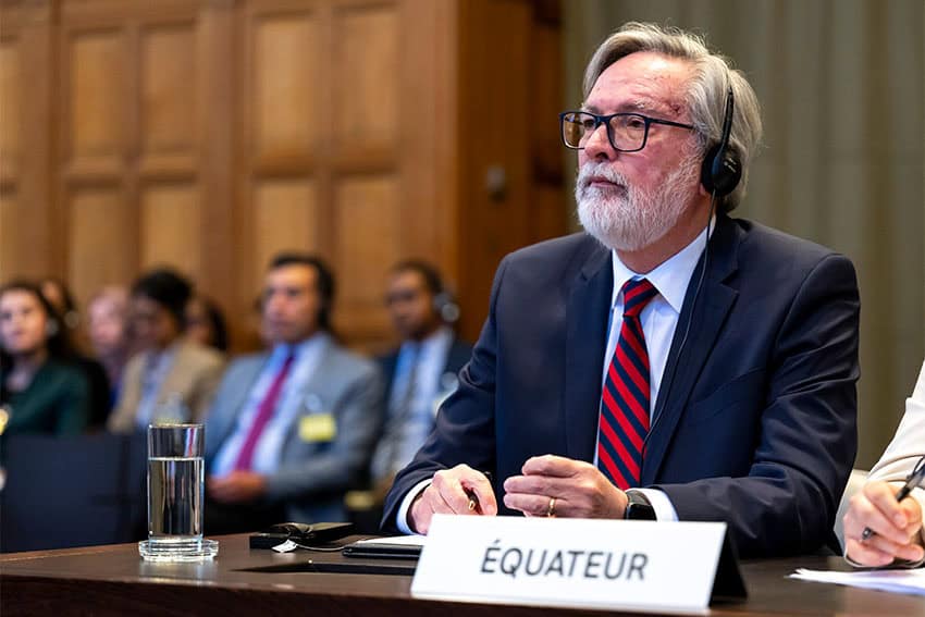Ecuador's ambassador to the Netherlands, Andrés Terán Parral sitting in a suit during proceedings of the International Court of Justice with translation headphones on.