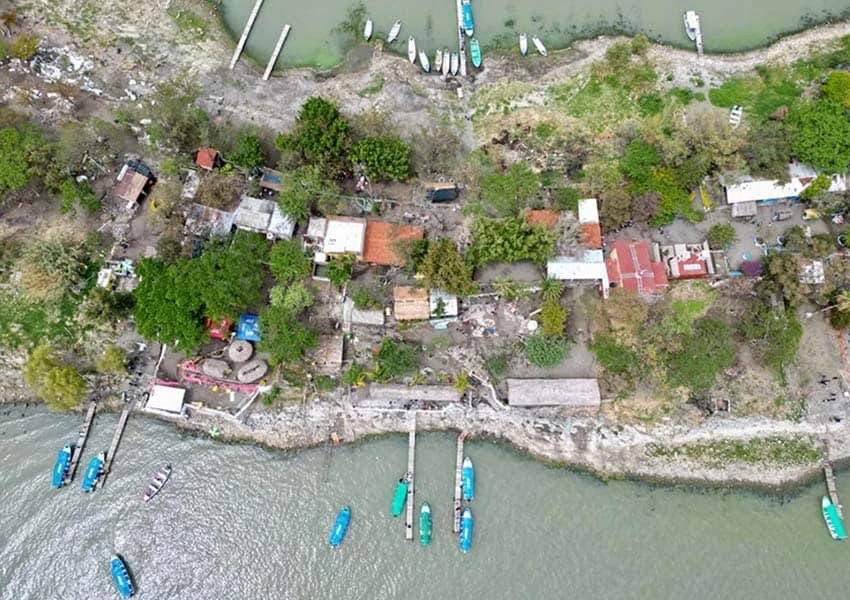 aerial image of Jalisco's Lake Chapala with docked ships on the shoreline and homes on land.