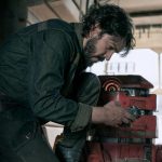 Actor Diego Luna, who will receive an award at the Guadalajara Film Festival, hunched over a machine part in a tool workshop in the Star Wars film "Andor"