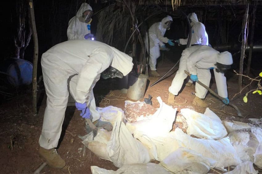 five people in hazmat suits removing chemicals from a drug lab in Sinaloa