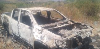 A burned white pickup truck