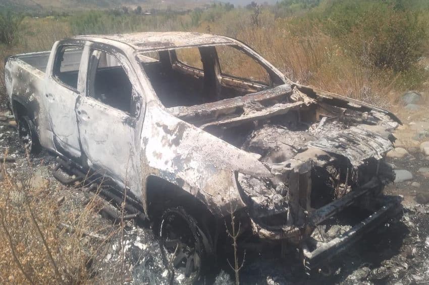 A burned white pickup truck