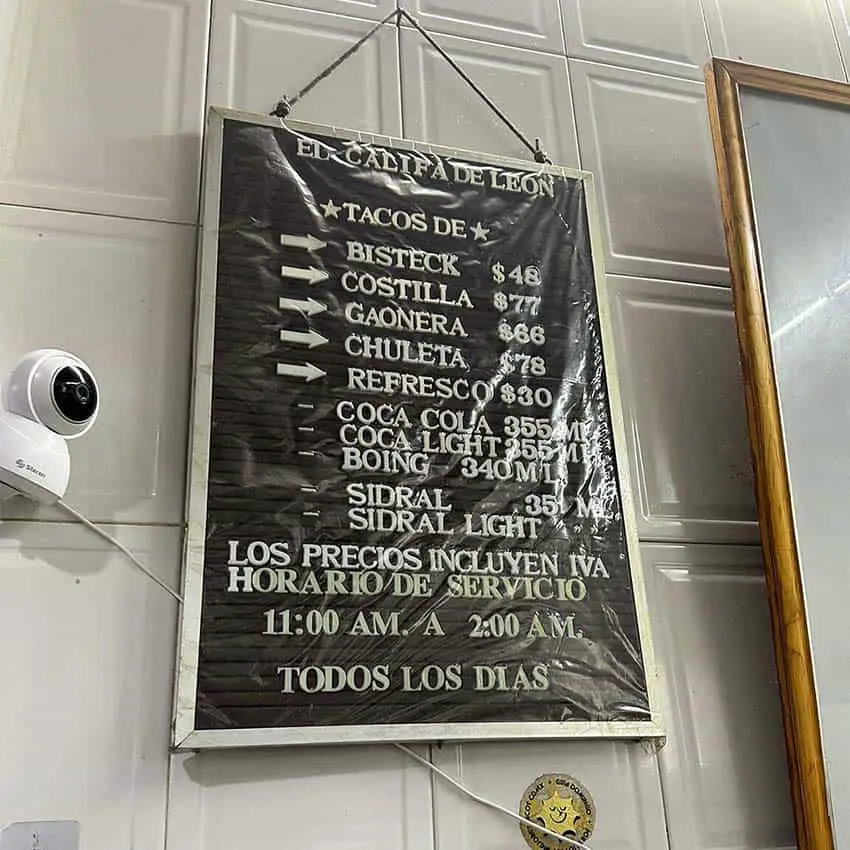 A sign showing the menu at El Califa de Leon, a Mexico City taqueria that just won a Michelin star