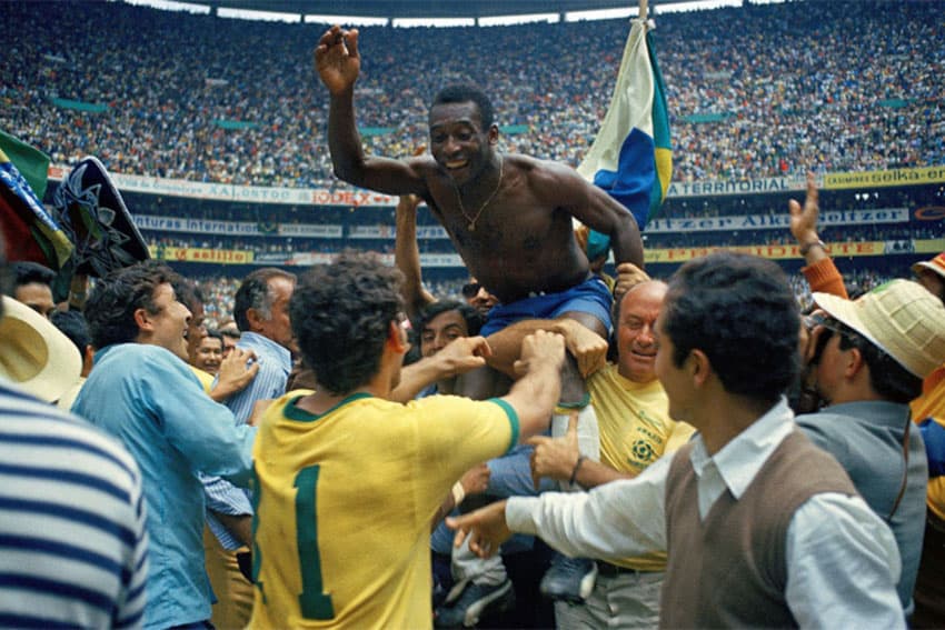 Brazilian soccer legend atop the shoulders of his teammates in the 1970 World Cup in Azteca Stadium, Mexico