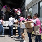 INE workers in Puebla unload ballot boxes for the Mexican elections, while soldiers and official observers watch.