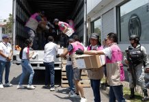 INE workers in Puebla unload ballot boxes for the Mexican elections, while soldiers and official observers watch.