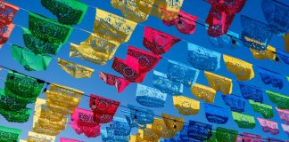 Colorful papel picado hanging in a Mexican town