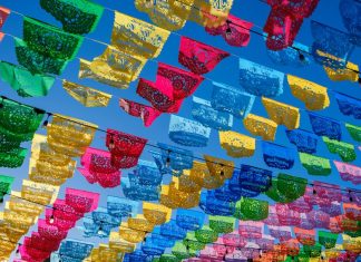 Colorful papel picado hanging in a Mexican town