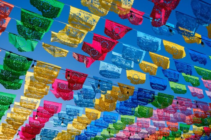 Colorful papel picado hanging in a Mexican town