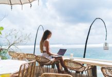 girl working from the beach as a digital nomad