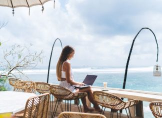 girl working from the beach as a digital nomad