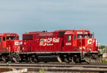 red Canadian Pacific Rail train on railroad tracks