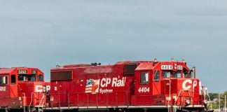 red Canadian Pacific Rail train on railroad tracks