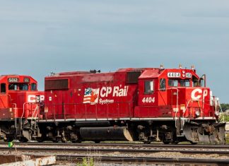 red Canadian Pacific Rail train on railroad tracks