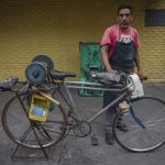 Knife sharpener on his bike
