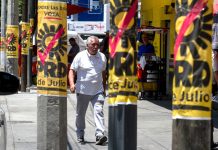 A man walks by PRD campaign posters on posts in Mexico City