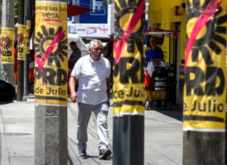Democratic Revolution Party (PRD) leader confirms the party’s demise A man walks by PRD campaign posters on posts in Mexico City