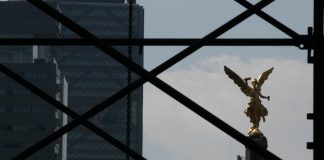 Mexico City's Angel of Independence appears behind scaffolding