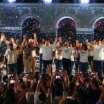 Mexico election results: Morena dominates gubernatorial races Morena gubernatorial candidate Javier May holds hands on stage with his campaign team, as confetti rains down.