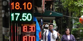 Posted currency exchange rates outside of a bank in Mexico in June 2024