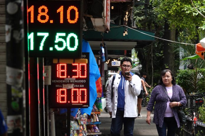 Posted currency exchange rates outside of a bank in Mexico in June 2024