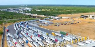 Hundreds of tractor trailers in stopped traffic, waiting to cross an international bridge on the Mexico-U.S. border in Laredo, Texas