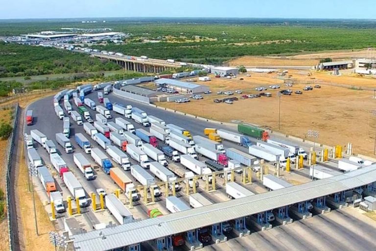 Hundreds of tractor trailers in stopped traffic, waiting to cross an international bridge on the Mexico-U.S. border in Laredo, Texas