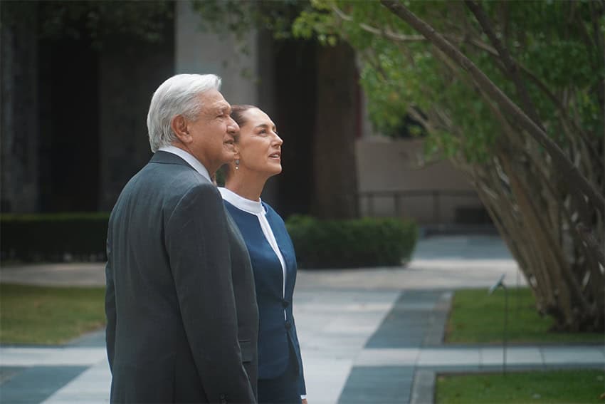 Claudia Sheinbaum and Andres Manuel Lopez Obrador standing in a courtyard looking off camera