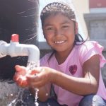 A smiling girl with clean water