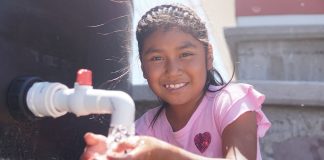 A smiling girl with clean water