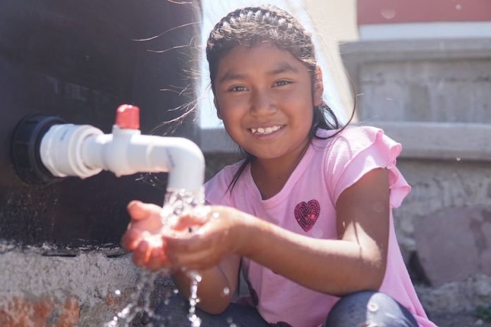A smiling girl with clean water