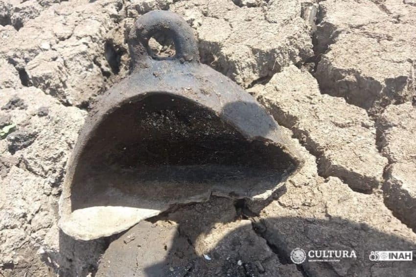 Part of a ceramic bell-shaped artifact found on the island of Janitzio, in Lake Pátzcuaro, shown sitting on dried-out mud