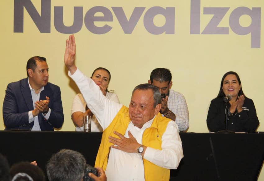Jesús Zambrano waves to reporters