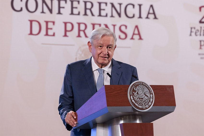 Mexico's President Lopez Obrador standing at the National Palace conference room podium