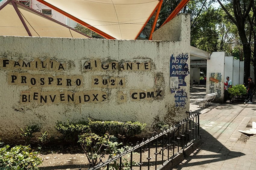 Paper letters glued to a wall welcome migrant families to the now-empty encampment in downtown CDMX.