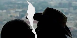 Couple kissing each other, but the photo is broken in half because they broke up