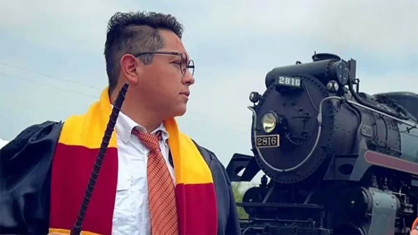 Ramón Andrade García dressed as Harry Potter for a photo shoot in front of the historic steam locomotive known as The Empress.