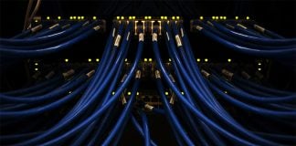 Blue cables, like those manufactured by Chinese telecoms manufacturer YOFC, plug into a computer.