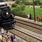 Bystanders gather to watch the passage of the Empress, a black steam locomotive, through Tula de Allende, Hidalgo, on its way to Mexico City.
