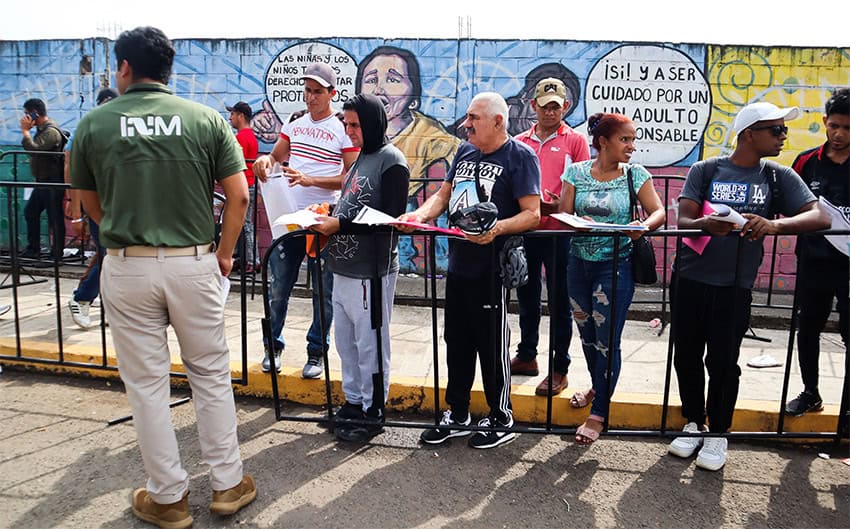 Foreigners wait in line with paperwork at the Tapachula office of the INM, near the border between Mexico and Guatemala. 
