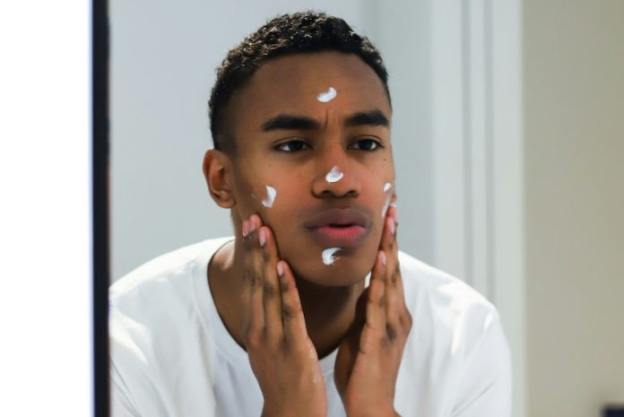 Man applying skincare cream