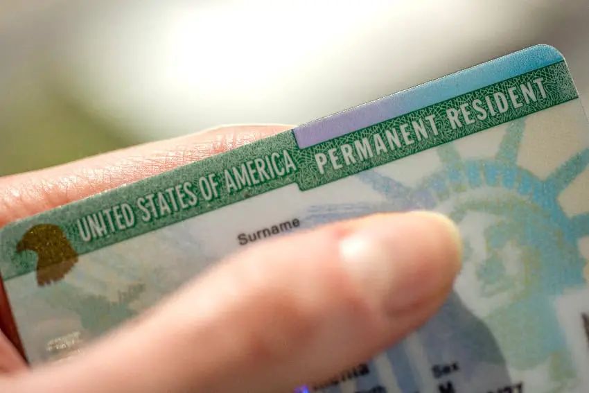 Hand holding a U.S. Permanent Resident card