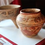 Woman returns US $4 thrift store vase to Mexico after realizing it’s an ancient Maya artifact Closeup of an ancient Maya vase with red figures painted on clay