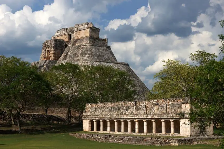 Uxmal archaeological site, with main pyramid in background and a colonnaded building in foreground