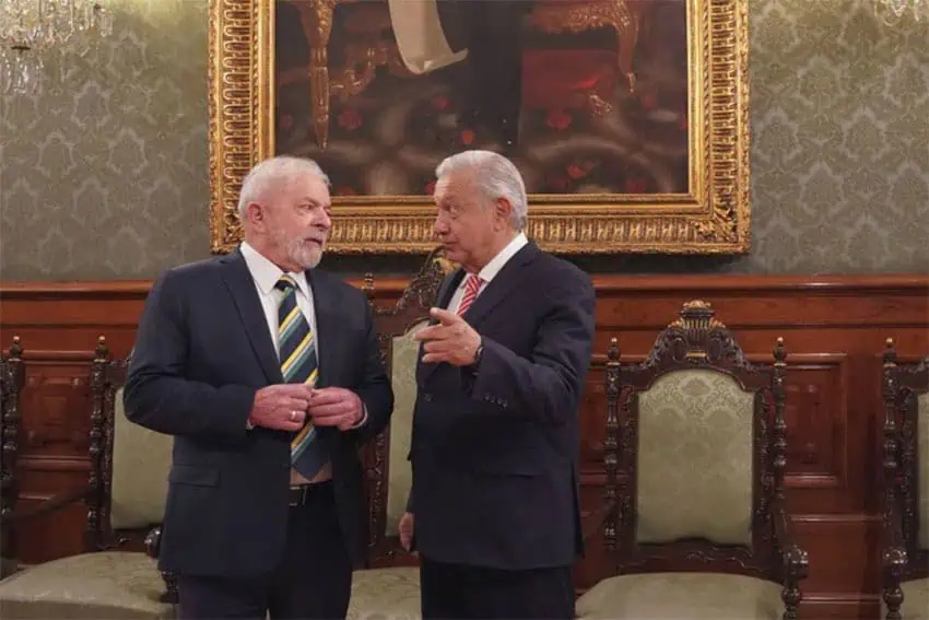 Mexico's President Lopez Obrador with Brazil's President Luiz Inácio Lula da Silva standing in an official room of Mexico's National Palace, gesturing as they converse. Brazil will be exempt from the U.S. steel and aluminum tariff policy.