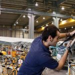 Airbus employee in a factory hangar working on an aircraft