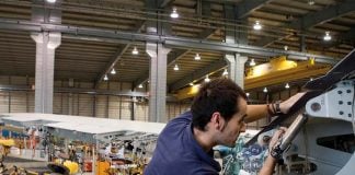 Airbus employee in a factory hangar working on an aircraft