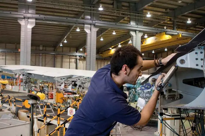 Airbus employee in a factory hangar working on an aircraft